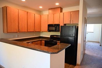 Kitchen with appliances Bella on Canyon Apartments in Puyallup Wa